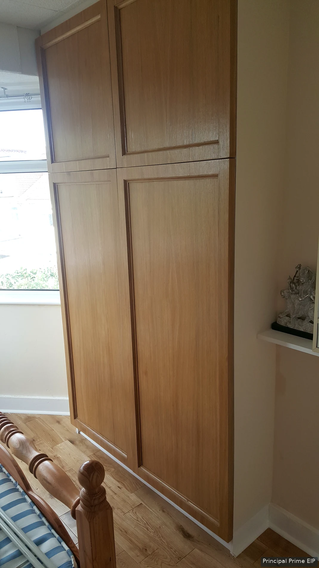Fitted oak cupboard beside a kitchen window Fitted oak cupboard beside a kitchen window