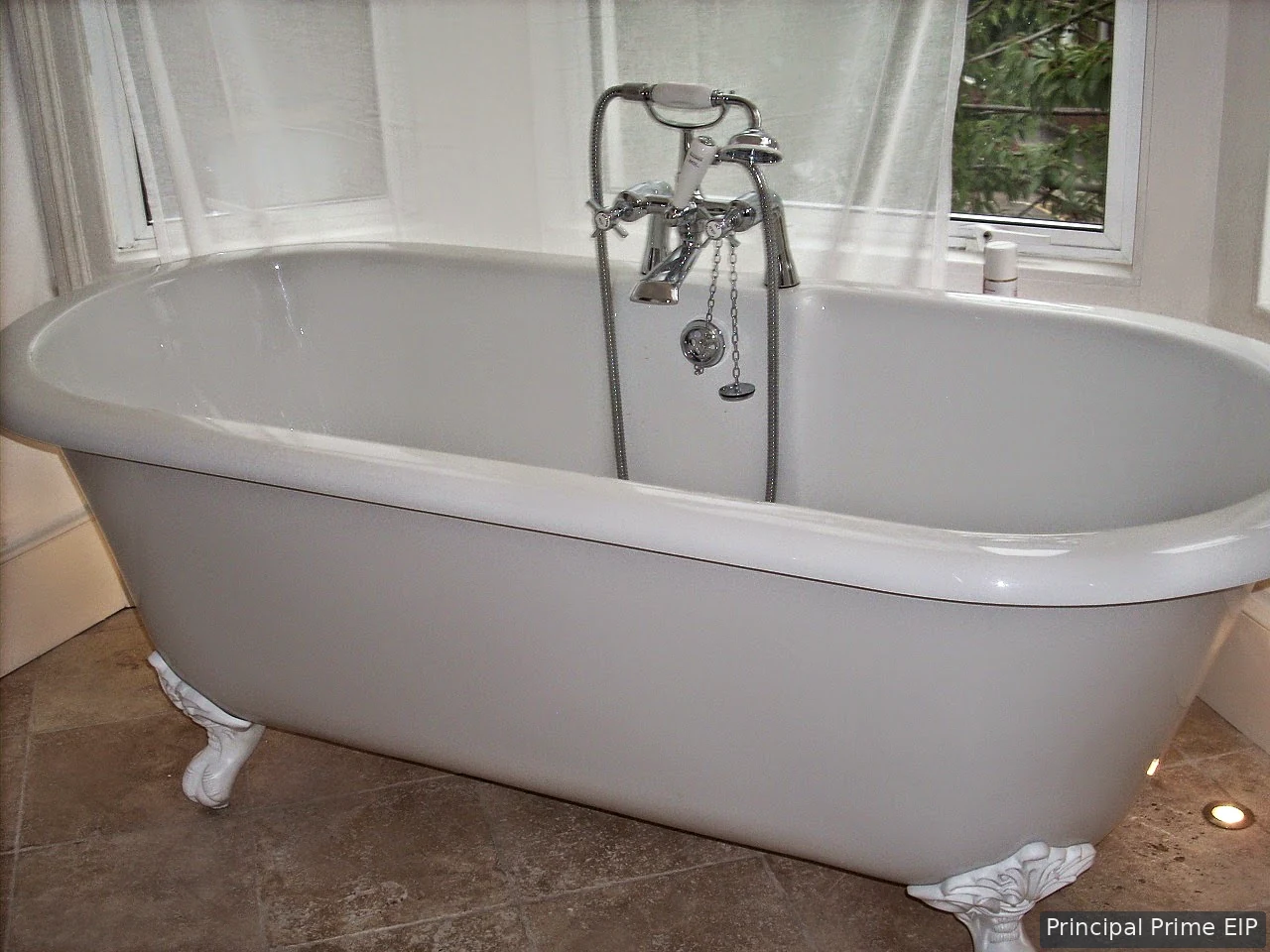 Freestanding roll-top bath with chrome mixer Freestanding roll-top bath with chrome mixer