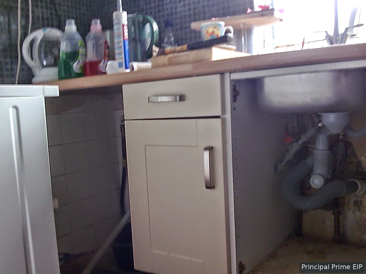 Kitchen plumbing connections beneath a sink Kitchen plumbing connections beneath a sink
