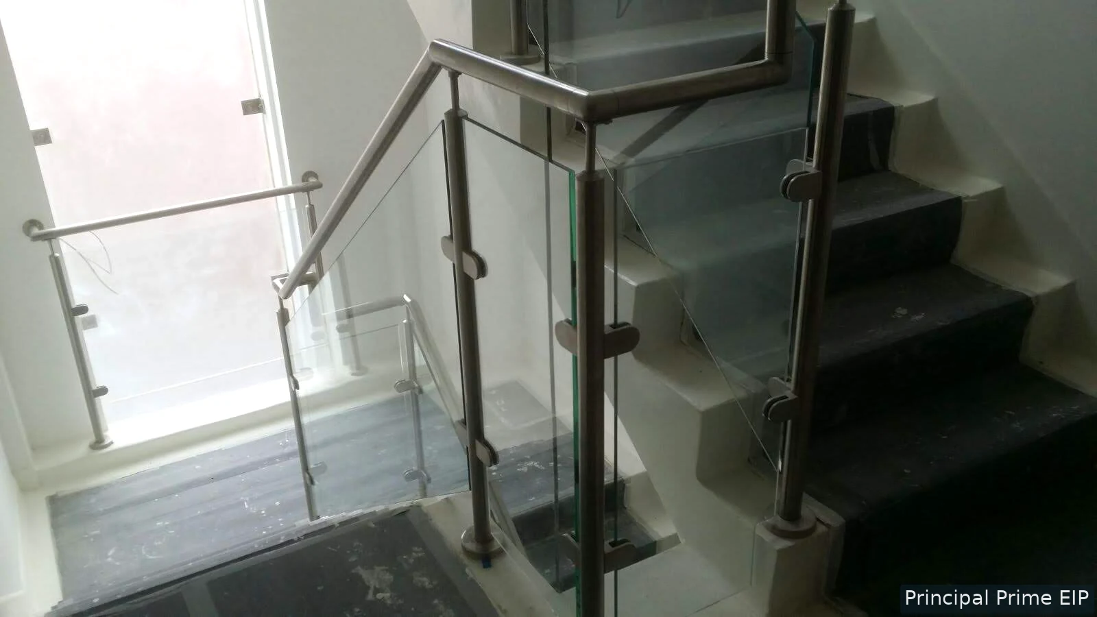 Staircase with glazed balustrade and metal handrail Staircase with glazed balustrade and metal handrail