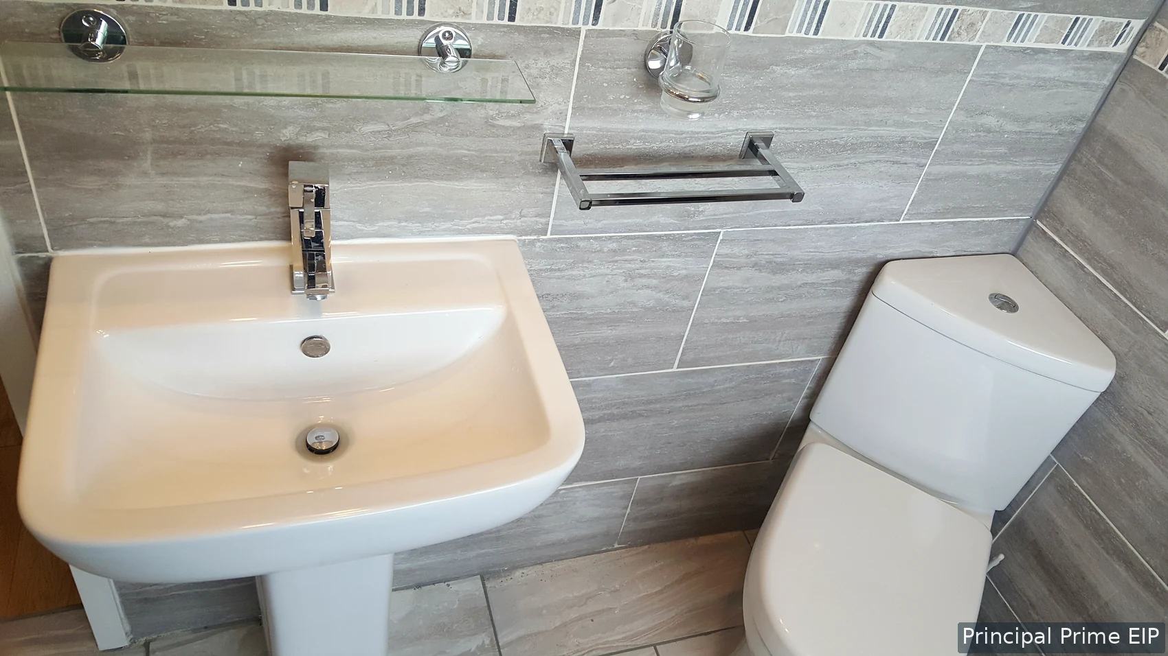 Basin and WC with stone-effect wall tiling Basin and WC with stone-effect wall tiling in Merton (SM4).