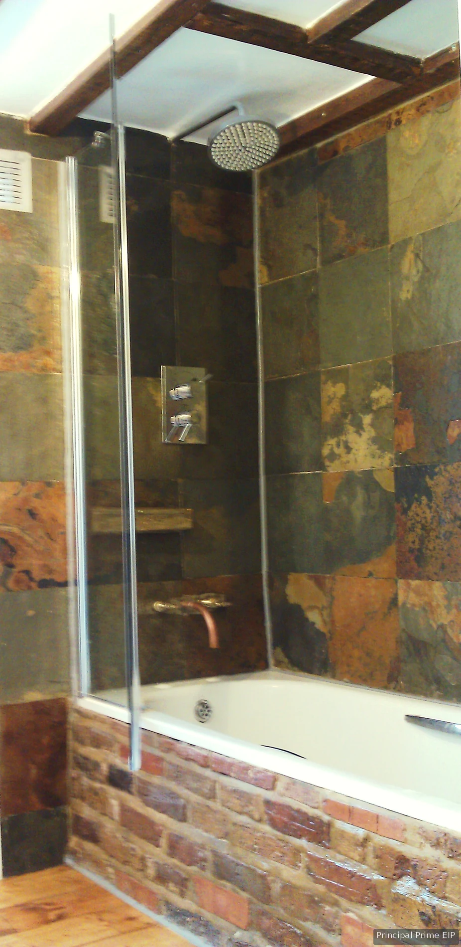 Brick bath surround with natural stone shower walls Brick bath surround with natural stone shower walls in Lambeth (SE21).