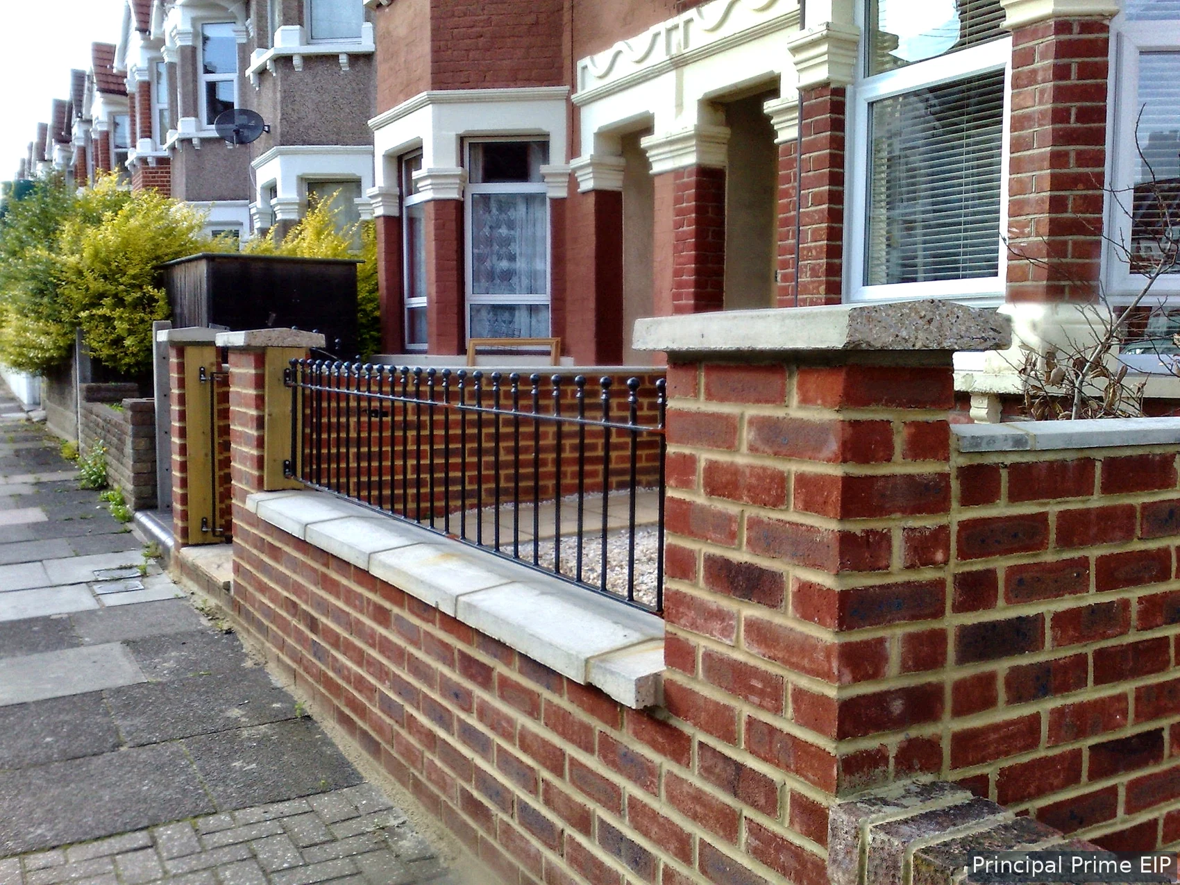 Brick boundary wall with fitted railings Brick boundary wall with fitted railings.