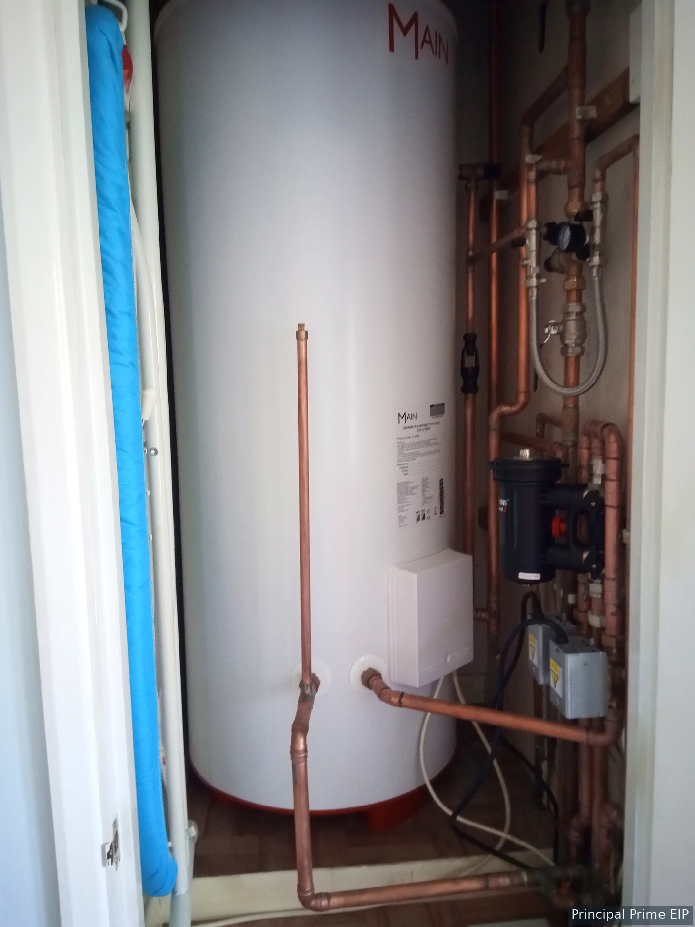 Hot-water cylinder with associated copper pipework Hot-water cylinder with associated copper pipework.